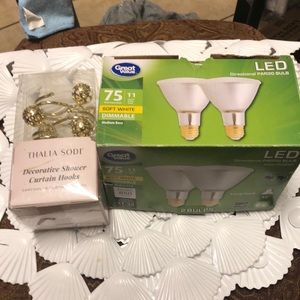 New shower curtain hooks, shower mat, and 2 unused (?) dimmable 75w like bulbs.